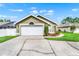Well-maintained home featuring an attached garage and manicured landscaping at 1706 Terra Cota Ct, Orlando, FL 32825