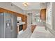 A well-lit kitchen featuring stainless steel appliances, white tile, and wood cabinets at 1706 Terra Cota Ct, Orlando, FL 32825