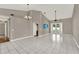 Large, open living room with tile flooring, vaulted ceilings, and backyard access at 1706 Terra Cota Ct, Orlando, FL 32825