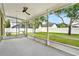 A screened-in patio area overlooks a neatly maintained lawn with a white fence at 1706 Terra Cota Ct, Orlando, FL 32825