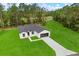 Aerial view of a home showing expansive lawn and a long driveway at 17465 Sw 41St Cir, Ocala, FL 34473