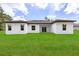 A large backyard features manicured green grass and modern architecture at 17465 Sw 41St Cir, Ocala, FL 34473