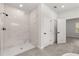 Modern bathroom features a large marble shower with black hardware and gray tile flooring at 17465 Sw 41St Cir, Ocala, FL 34473