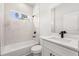 Modern bathroom features white marble tile, black fixtures, and a window at 17465 Sw 41St Cir, Ocala, FL 34473