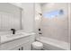 Modern bathroom showcasing a tub, marble-style tile, a window, and updated fixtures at 17465 Sw 41St Cir, Ocala, FL 34473