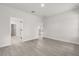 Bright bedroom with wood floors and an open doorway at 17465 Sw 41St Cir, Ocala, FL 34473