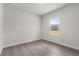 This bedroom features wood floors, natural light from the window, and neutral paint at 17465 Sw 41St Cir, Ocala, FL 34473