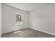 Bright bedroom featuring gray floors and a window with views of the exterior scenery at 17465 Sw 41St Cir, Ocala, FL 34473
