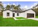 Charming single-story home featuring a well-manicured lawn and a two-car garage at 17465 Sw 41St Cir, Ocala, FL 34473