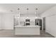 Bright kitchen with stainless steel appliances, center island, and modern pendant lighting at 17465 Sw 41St Cir, Ocala, FL 34473