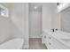 Bright bathroom featuring a modern tub, double vanity, and walk-in shower at 17501 Sw 41St Cir, Ocala, FL 34473