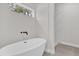 Luxurious bathroom featuring a soaking tub and walk-in shower with marble tile at 17501 Sw 41St Cir, Ocala, FL 34473