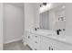 Bright bathroom with double vanity, white cabinetry, modern fixtures, and a large mirror at 17501 Sw 41St Cir, Ocala, FL 34473