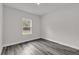 Cozy bedroom with beautiful flooring and a window overlooking lush greenery at 17501 Sw 41St Cir, Ocala, FL 34473
