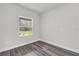 Bright bedroom features durable gray flooring and a view to the outdoors at 17501 Sw 41St Cir, Ocala, FL 34473