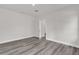 Bedroom features durable gray flooring, neutral paint, and access to other rooms at 17501 Sw 41St Cir, Ocala, FL 34473