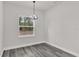Bright dining room with a decorative hanging light fixture and large window at 17501 Sw 41St Cir, Ocala, FL 34473