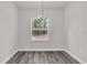 Charming dining room featuring a window and a hanging light fixture at 17501 Sw 41St Cir, Ocala, FL 34473