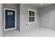 Close up of the entrance and sidelight window of the single story home with a blue front door at 17501 Sw 41St Cir, Ocala, FL 34473
