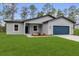 Charming single-story home with a blue garage door and freshly manicured front lawn at 17501 Sw 41St Cir, Ocala, FL 34473