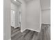 Hallway with modern gray flooring connecting to a well-lit bathroom at 17501 Sw 41St Cir, Ocala, FL 34473