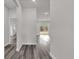 Bright hallway with wood-look floors leads to an open living space with sliding glass doors to the backyard at 17501 Sw 41St Cir, Ocala, FL 34473