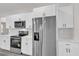 Modern kitchen features stainless steel appliances, white cabinets, and a built-in microwave at 17501 Sw 41St Cir, Ocala, FL 34473