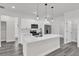 Modern kitchen featuring an island, stainless steel appliances, sleek cabinets, and grey floors at 17501 Sw 41St Cir, Ocala, FL 34473