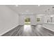 Spacious living room with sliding glass doors, grey flooring, and an open floor plan at 17501 Sw 41St Cir, Ocala, FL 34473