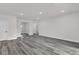 Bright and spacious living room with gray wood-look flooring and neutral walls at 17501 Sw 41St Cir, Ocala, FL 34473