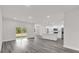 Spacious living room featuring gray wood-look flooring and an open concept kitchen at 17501 Sw 41St Cir, Ocala, FL 34473