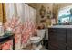 Cozy bathroom featuring a cherry blossom shower curtain and vanity with modern dark wood cabinets at 1907 Myakka Ct, Poinciana, FL 34759