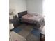 Simple bedroom with a full-sized bed and functional decor in a compact space at 1907 Myakka Ct, Poinciana, FL 34759