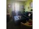 Intimate living room with dark leather sofa, featuring neutral decor with pops of color at 1907 Myakka Ct, Poinciana, FL 34759