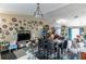 Spacious living area with dining table and chairs, perfect for entertaining guests at 1907 Myakka Ct, Poinciana, FL 34759