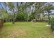 Large backyard featuring mature trees, grass, and a fenced perimeter for privacy at 191 Ruskin St, Lake Mary, FL 32746