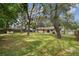 Backyard with mature trees, green grass, partial fencing, and access to the home at 191 Ruskin St, Lake Mary, FL 32746
