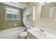 Bathroom with a tiled tub, shower, vanity with storage, and natural light at 191 Ruskin St, Lake Mary, FL 32746