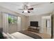 Cozy bedroom with a ceiling fan, tv, and a large window at 191 Ruskin St, Lake Mary, FL 32746
