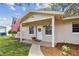 Inviting entrance with a covered porch and American flag waving at 191 Ruskin St, Lake Mary, FL 32746