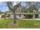 Charming single-story home with a well-maintained lawn and mature tree providing shade at 191 Ruskin St, Lake Mary, FL 32746
