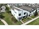 Modern two-story home featuring a manicured lawn and stylish architectural design at 2035 White Feather Loop, Oakland, FL 34787