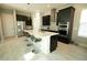 Modern kitchen features a large center island, sleek cabinetry, and stainless steel appliances at 2035 White Feather Loop, Oakland, FL 34787