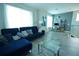 Cozy living room featuring a plush sofa, modern decor, and a dedicated workspace at 2035 White Feather Loop, Oakland, FL 34787