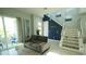 Bright living room with modern staircase, contemporary furnishings and open floor plan at 2035 White Feather Loop, Oakland, FL 34787