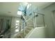 Modern staircase with metal railings, statement lighting, and contemporary artwork in the entryway at 2035 White Feather Loop, Oakland, FL 34787