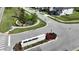 Landscaped Oakland Trails neighborhood entrance with stone signage and flower beds at 2035 White Feather Loop, Oakland, FL 34787
