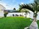 Expansive backyard with a seating area, lush lawn, privacy fence and tropical landscaping at 2051 Sandy Garden Ln, Winter Garden, FL 34787