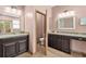 Luxurious bathroom with dual sinks, dark cabinetry, granite countertops, and a separate toilet area at 2051 Sandy Garden Ln, Winter Garden, FL 34787