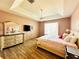 Comfortable bedroom features include a tray ceiling, wood flooring, a ceiling fan and natural light at 2051 Sandy Garden Ln, Winter Garden, FL 34787
